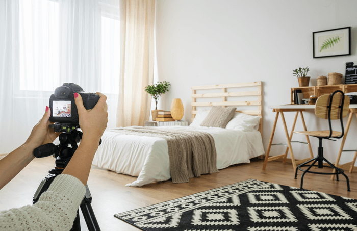 A person taking photos for vacation rental advertising