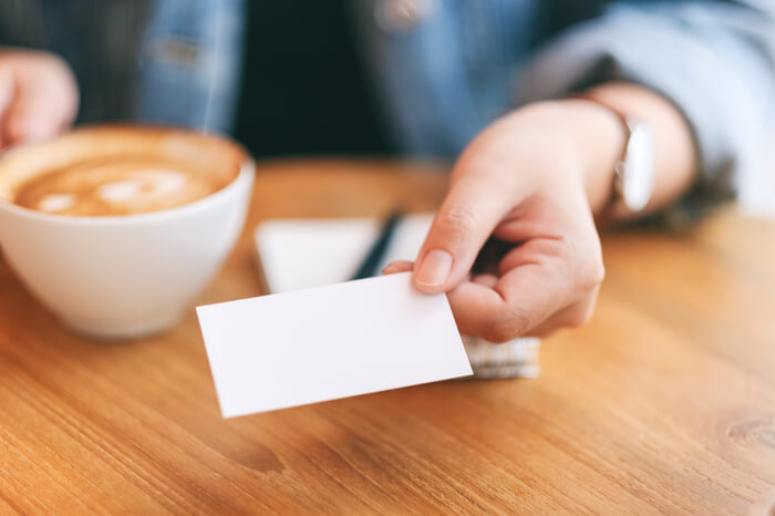 A host handing out an Airbnb business card