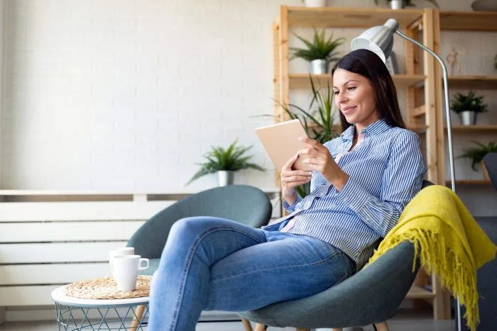 Woman reading Airbnb house manual template at home